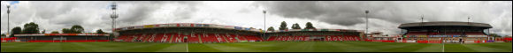 A panoramic photograph of Whaddon Road taken from the centre-spot