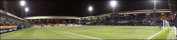 A panoramic photo of a floodlit Kenilworth Road