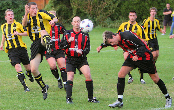 Luke Ballinger flies in for a cross against Longlevens