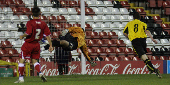 Luke Ballinger's header beats Stephen Henderson to score City's consolation goal