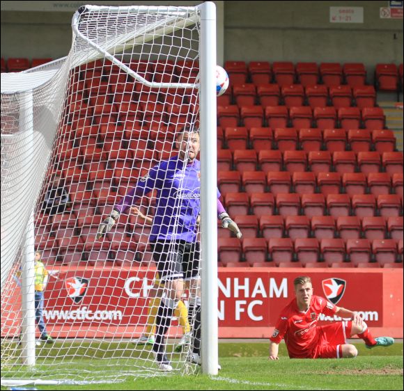 Chorley goalkeeper Sam Ashton can only watch as Harry Williams' header goes in off of the post