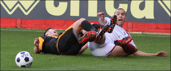 Steve Davies screams out after being fouled by a Colwyn Bay defender