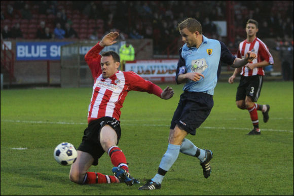 Darren Edwards slots home City's second goal at Altrincham today