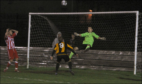 The Scuzzer's goalkeeper stops a Darren Edwards point blank header