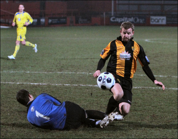 Darren Edwards is sent tumbling by Guiseley keeper Steve Drench for a penalty