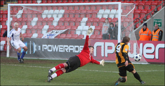 Motors' keeper Scott Tynan's dive forces Darren Edwards to shoot over the bar in the last minute