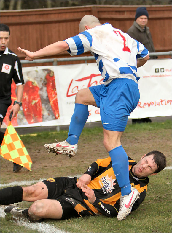 City defender Mike Green goes in where it hurts against Oxford City player Paul Stonehouse