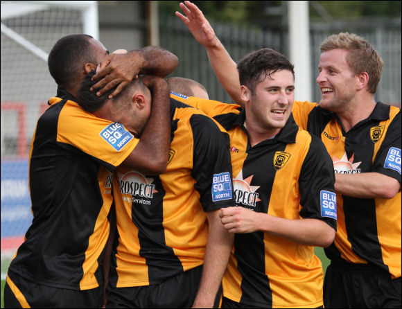 Tom Hamblin is mobbed by his teammates after his injury time winner against Stalybridge