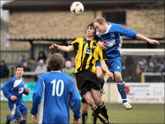 Jack Harris is beaten in the air by Chippenham's David Pratt