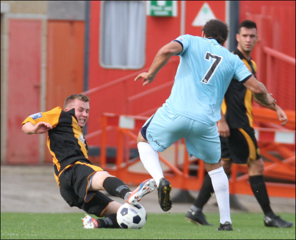 Jordan Goddard goes in over the ball with Damian Scannell