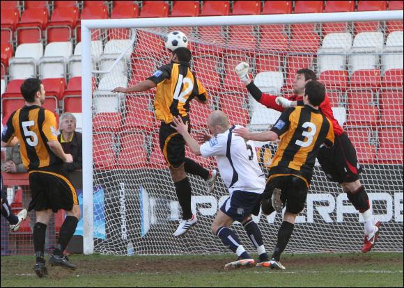 Theo Lewis rises highest to equalise on his debut against Guiseley