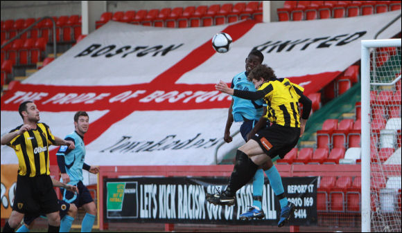 Lewis Pountney jumps for a header with an extremely large flag in the background!