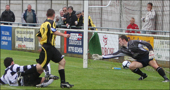 Luke Ballinger sweeps home City's third goal against Merthyr