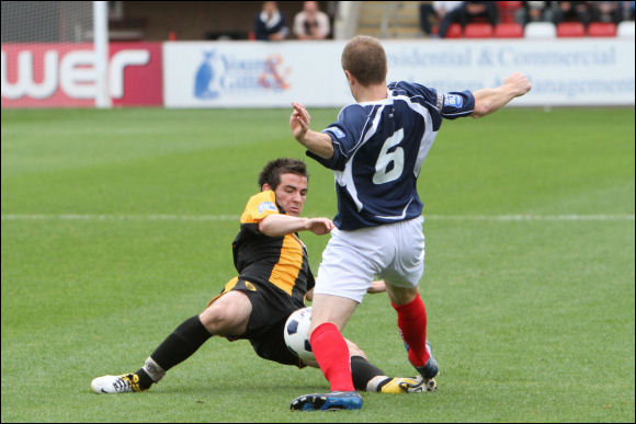 Adam Mann dives in to tackle Hyde Captain David Birch