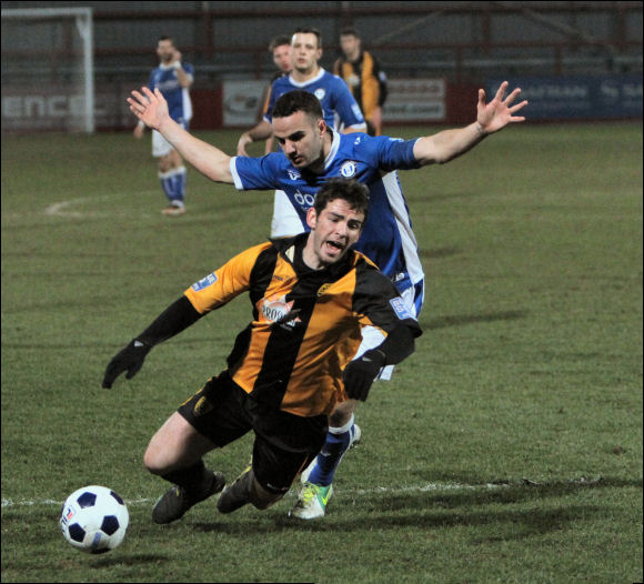 Penalty! Adam Mann goes down under a challenge from Halifax Captain Danny Lowe