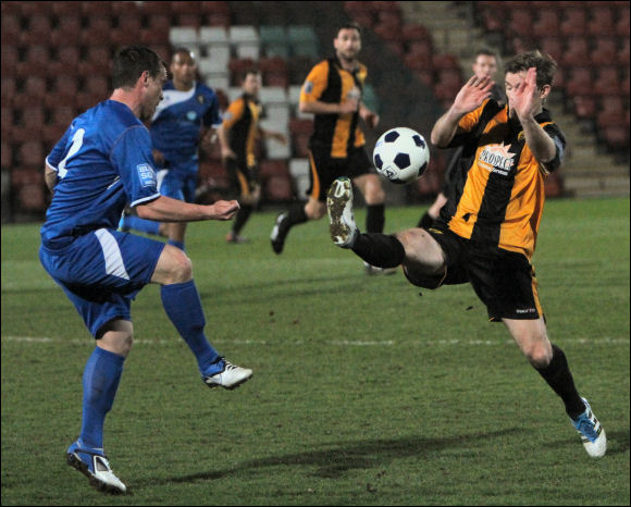 Matt Lock closes down a clearance from Gainsborough's Dominic Roma