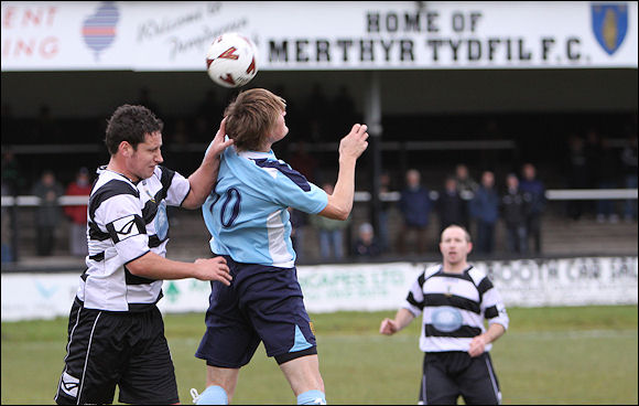 Will Morford jumps for a high ball at Merthyr Tydfil