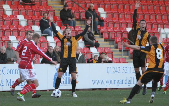 City players appeal in vain after a blatant handball from a Workington player