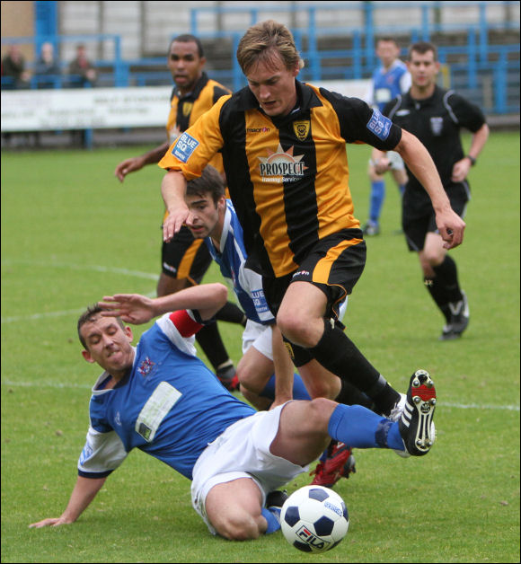 Will Morford is tripped by Stalybridge captain Rhys Meynell during today's game