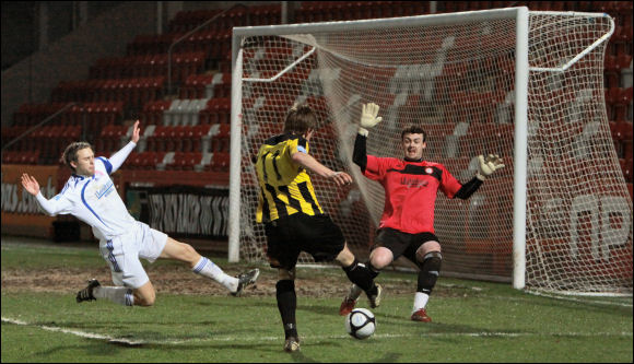 Will Morford shoots from a narrow angle against Vauxhall Motors