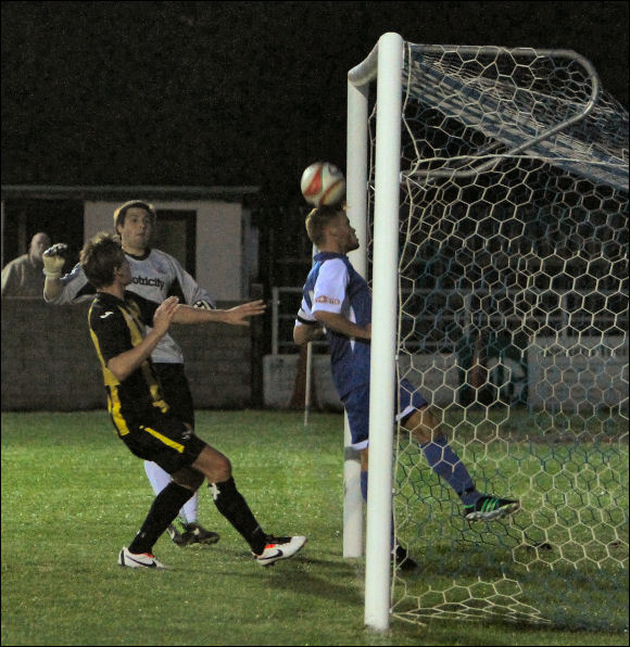 A Cleeve defender clears Darren Edwards' chip off of the line