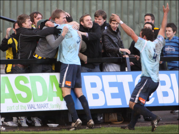 Ollie Barnes celebrates his goal with some of the City fans