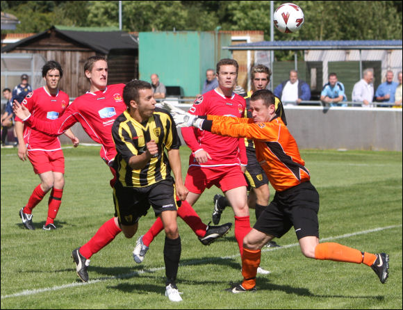 Jack Pitcher beats Chasetown goalkeeper Ryan Price to the ball to make it 2-2