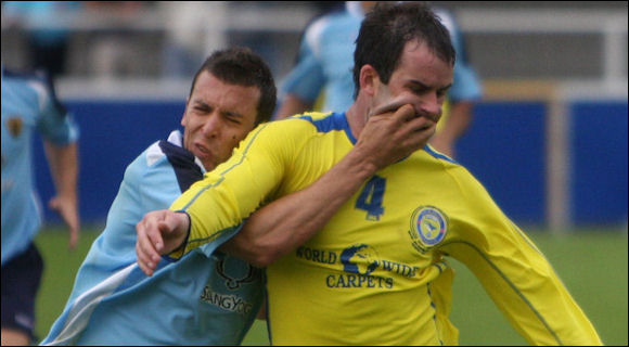 Jack Pitcher grapples with Farnborough defender Dave Woozley