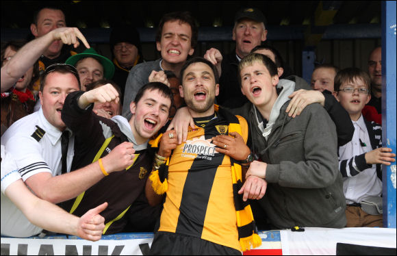 Retiring midfielder Matt Rose is mobbed by the City fans after the game