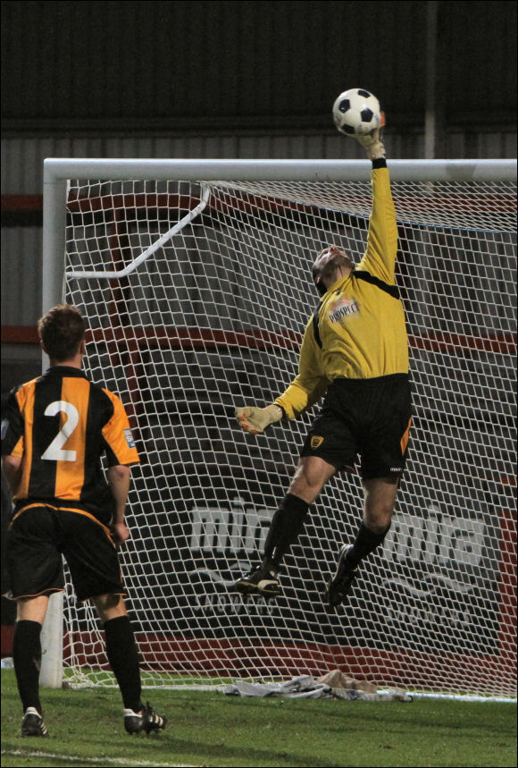 Stand-in Goalkeeper Matt Rose turns away a lob from Hinckley's Andy Gooding