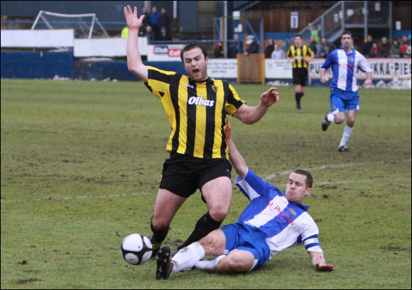 Worcester Captain Ryan Clarke executes a perfect sliding tackle on City's Mike Symons