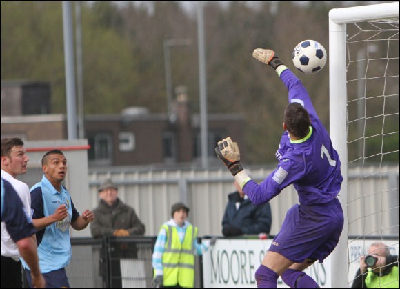 Theo Lewis watches as his header beats the keeper and rebounds off of the post