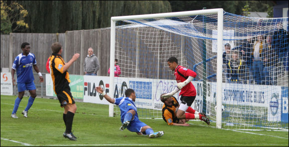 Tom Webb watches as his shot squirms inside the near post to make it 2-3