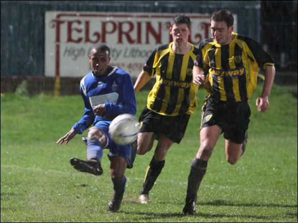 Tom Webb and Matt Walsh fail to prevent Halesowen's Shane Paul from clearing the ball